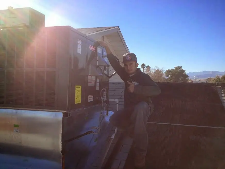 HVAC technician performing HVAC Inspection on a rooftop unit in Cleburne